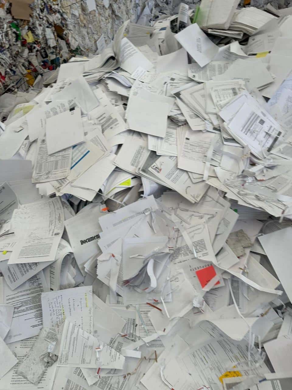 Documentos de papel y expedientes acumulados en el área de destrucción, listos para triturarse y reciclarse